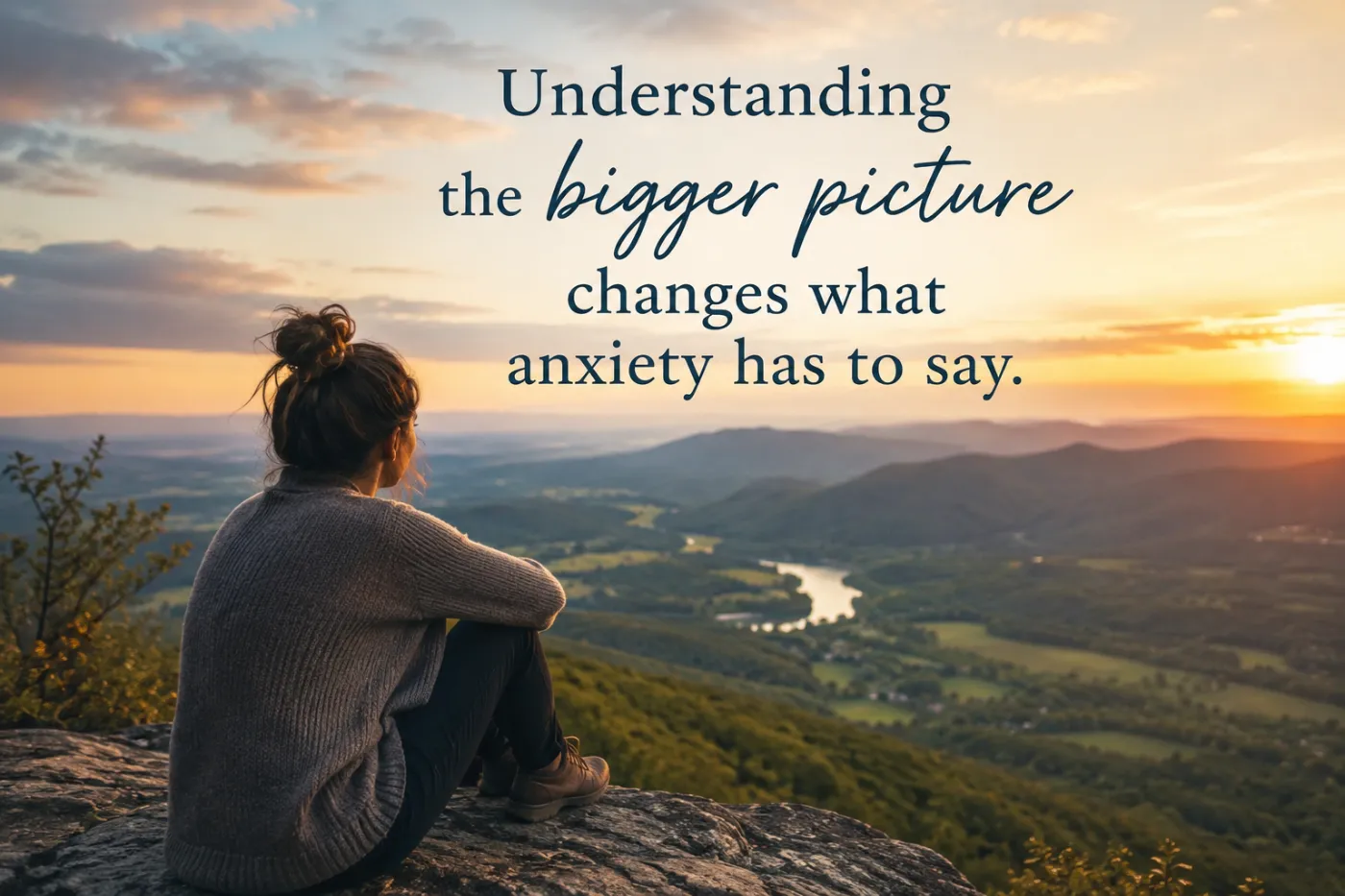 Woman looking out over mountain vista at sunrise